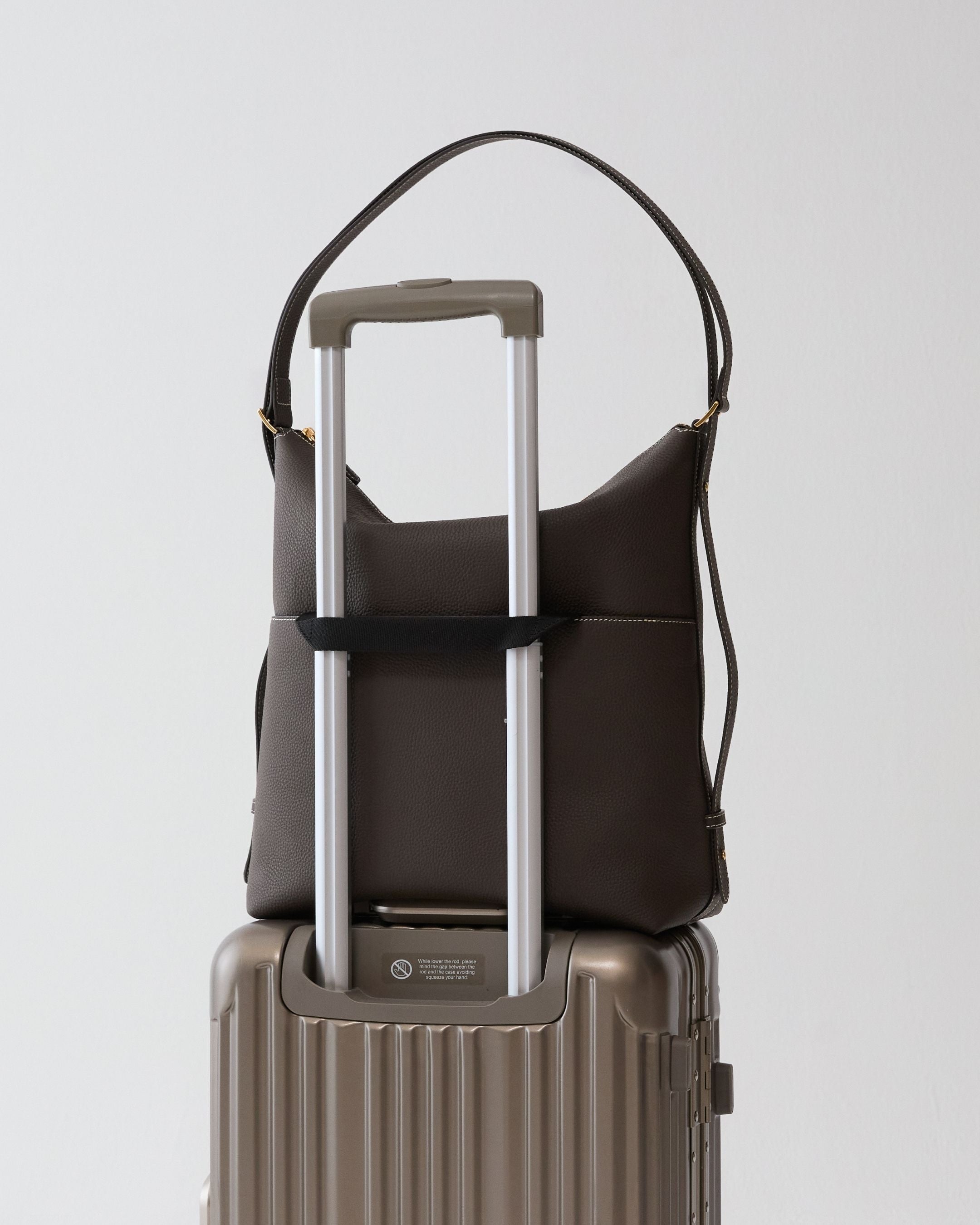 ALEMI Zurich | LETTEN | Laptop Bag | Dark Brown | Soft Grain Leather | Bag on suitcase